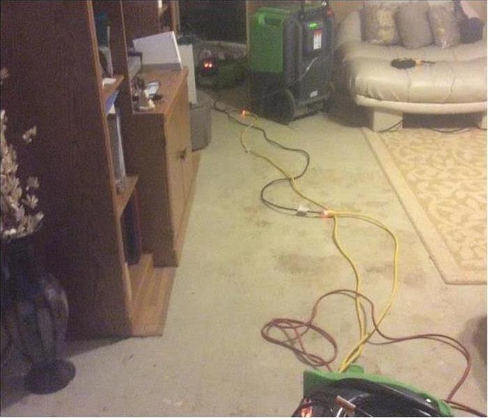 green drying equipment in water damaged living room
